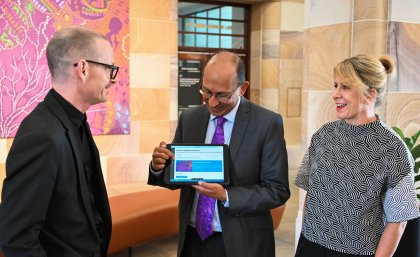 UQ Chancellor Peter Varghese shows staff early adopters, Professor Greg Hainge (left) and Sybilla Wilson (right) the Core Cultural Learning website.